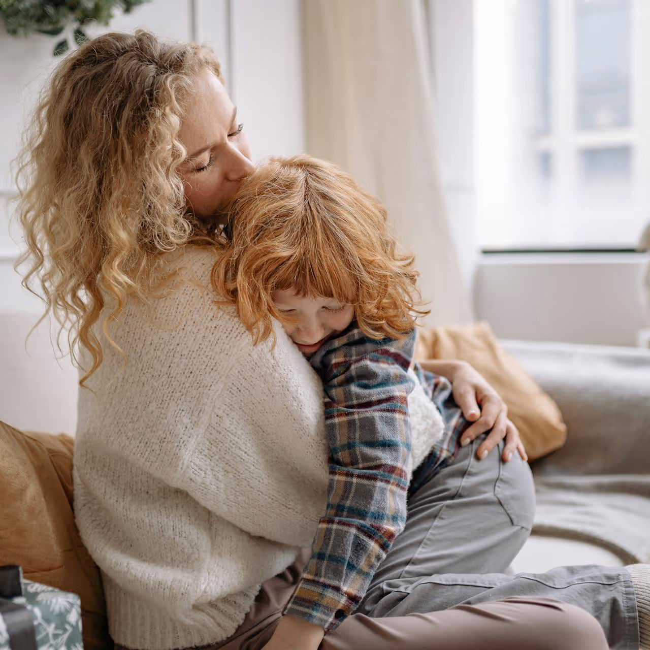 A mum giving her son a cuddle.