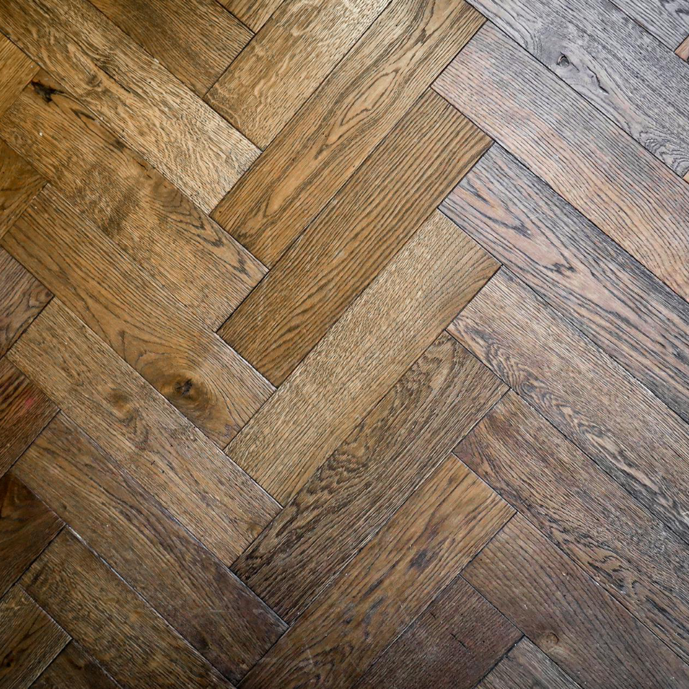 A dark oak parquet floor in a herringbone pattern.