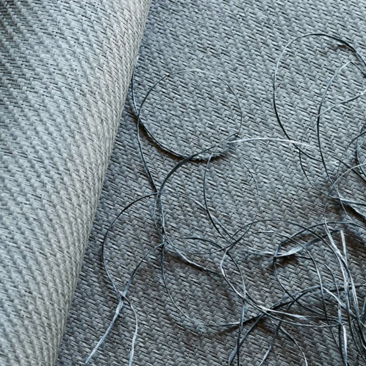 A sample of grasscloth wallpaper in a light ocean blue colour.