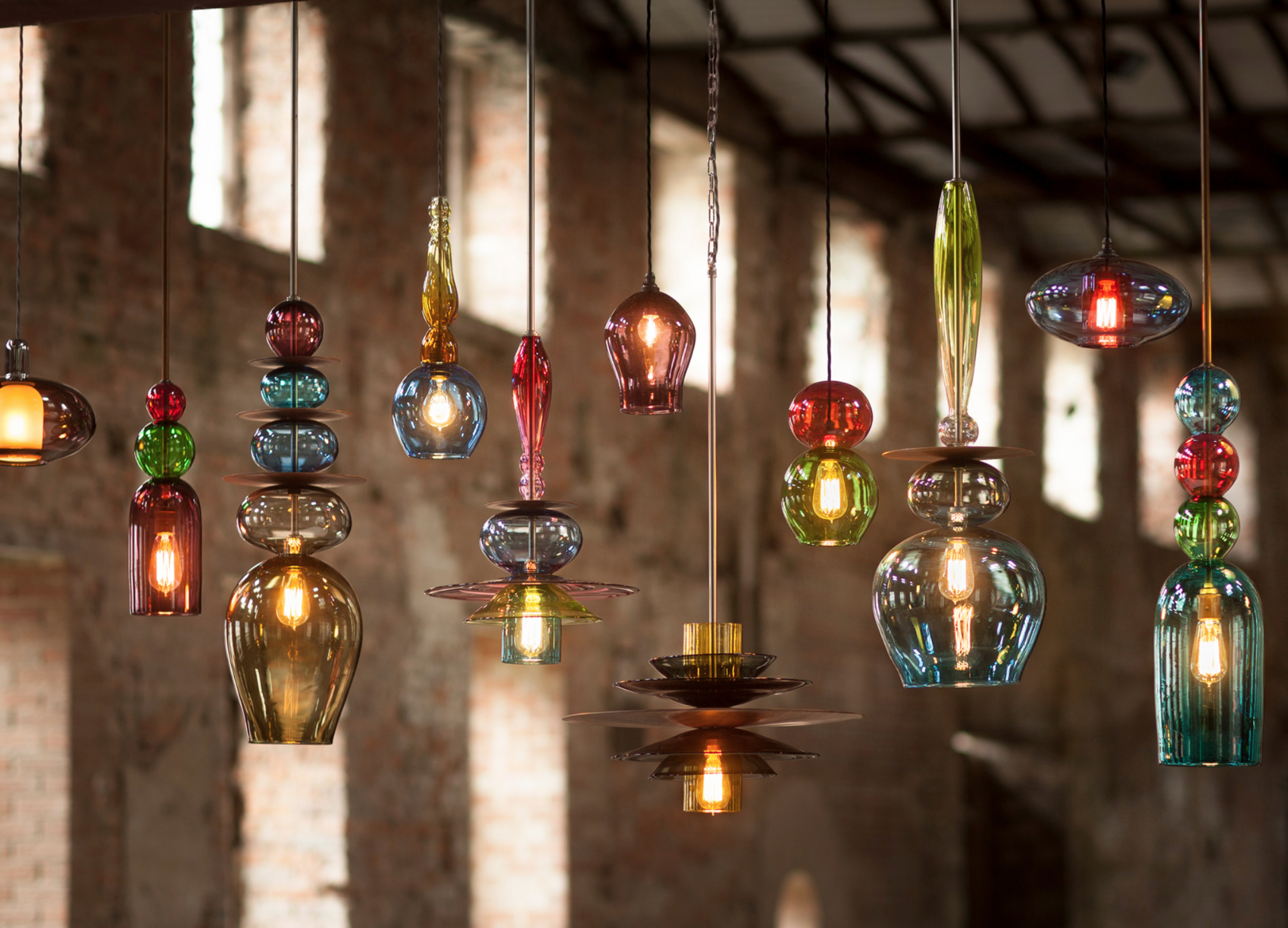 A row of handmade coloured glass lighting pendants
