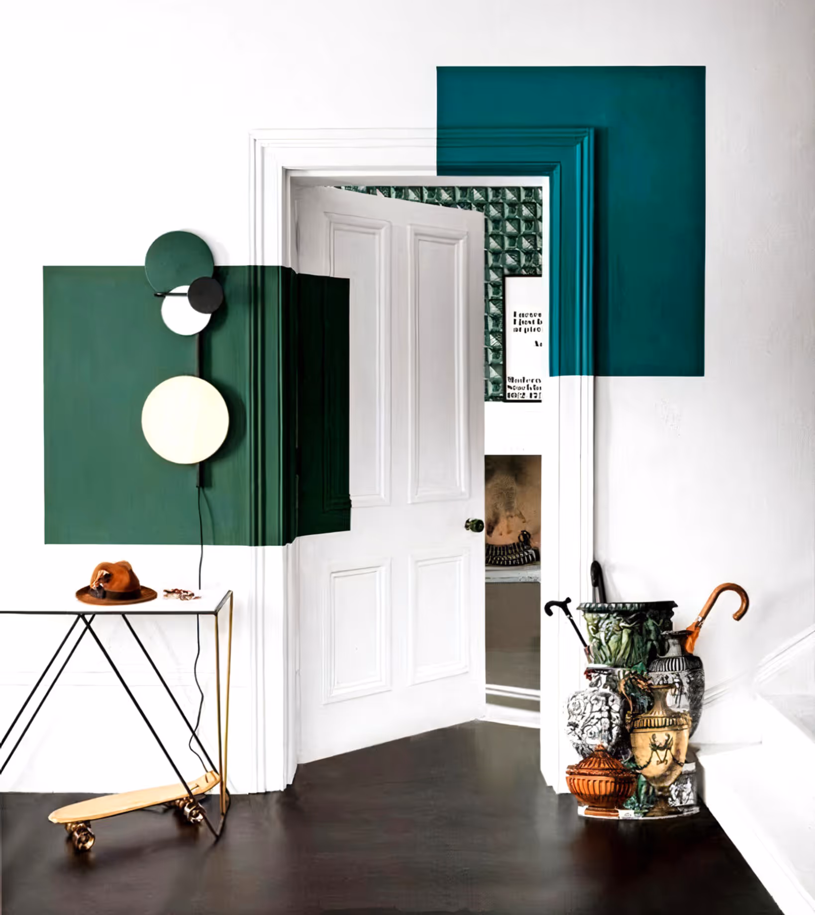 A white hallway with striking blocks of colour in dark green and teal