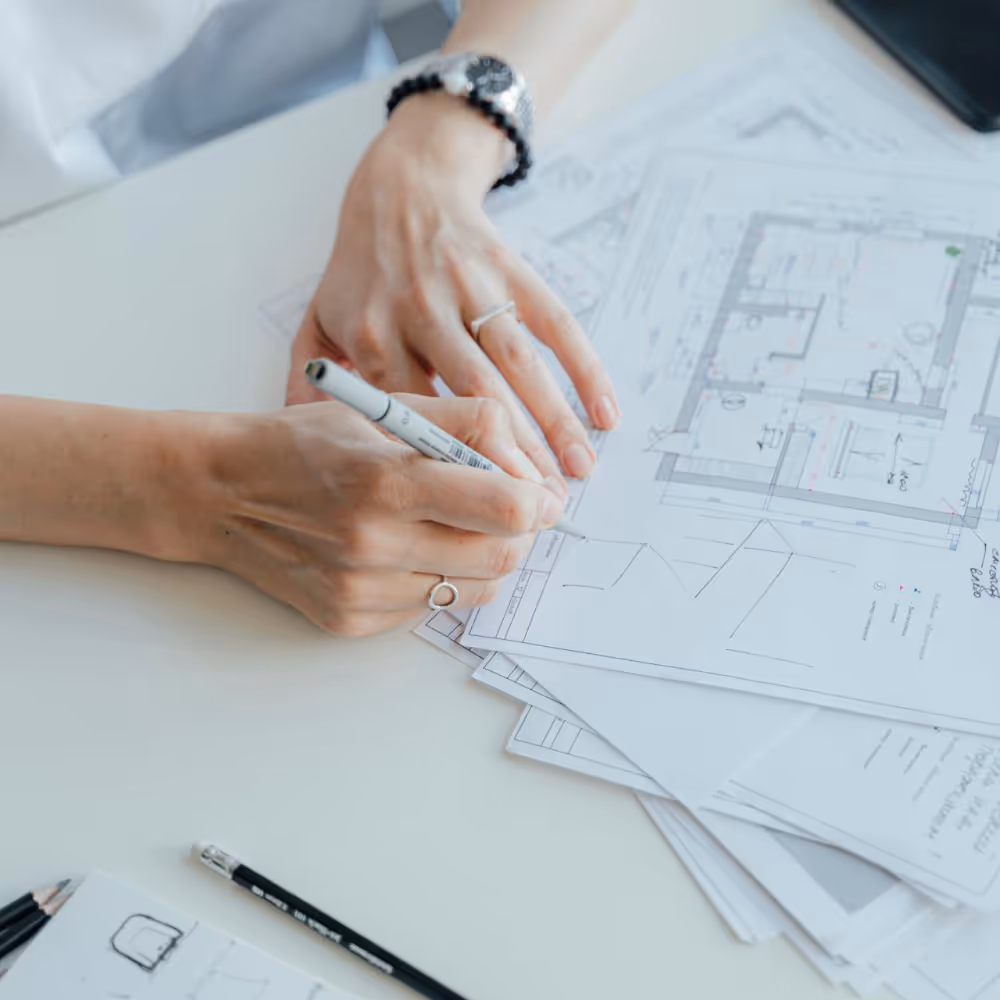 Someone signing off some architectural drawings