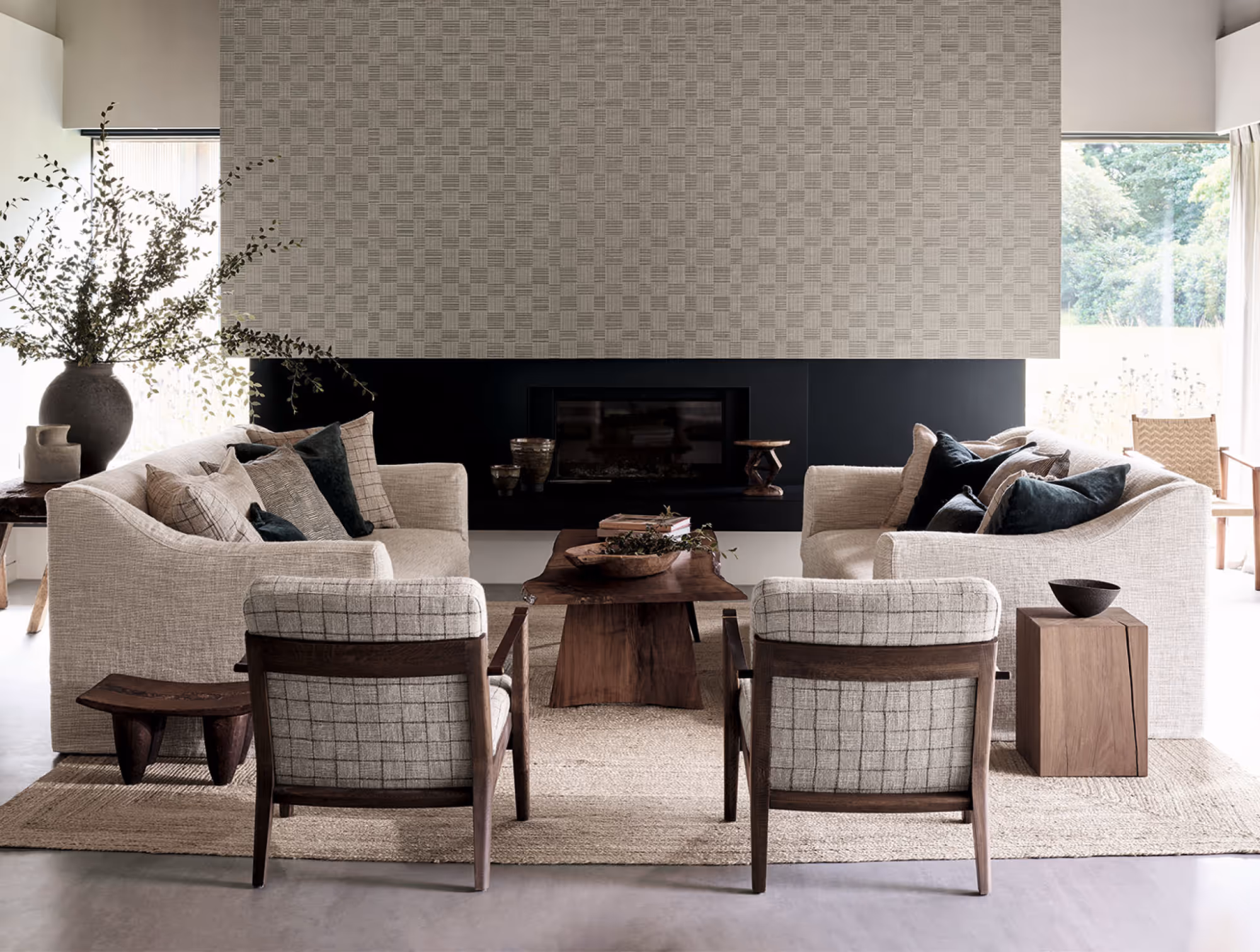 A mid century style room with a central fire and natural furnishings