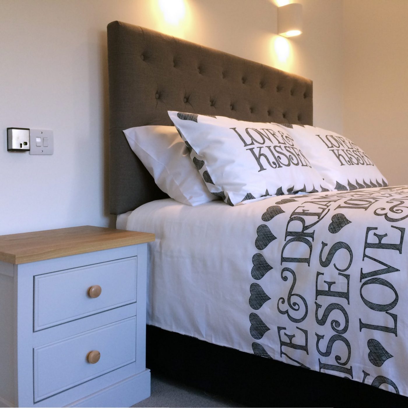 Bedroom of a holiday home with bed and bedside