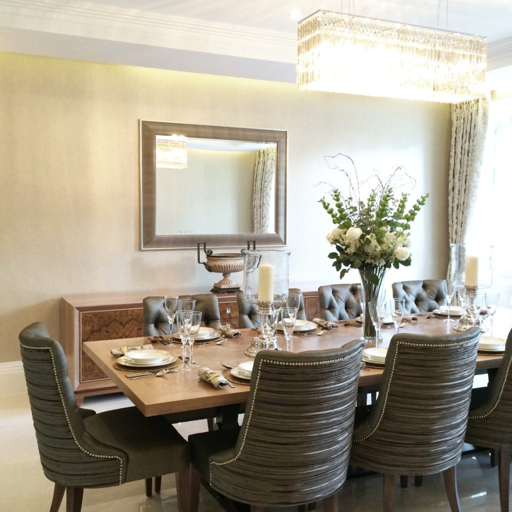 Grand dining room with a contemporary walnut dining table and pin tuck satin dining chairs