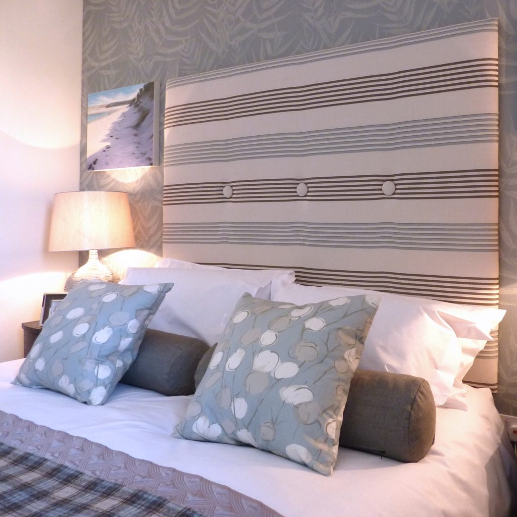 Coastal themed bedrooms with a deck chair striped headboard