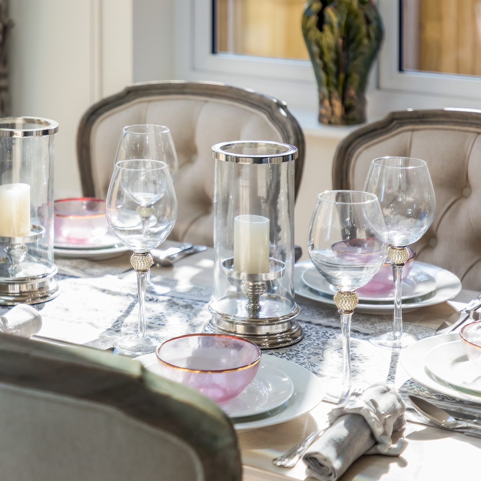 Dining table with button back chairs, set for a dinner party with friends