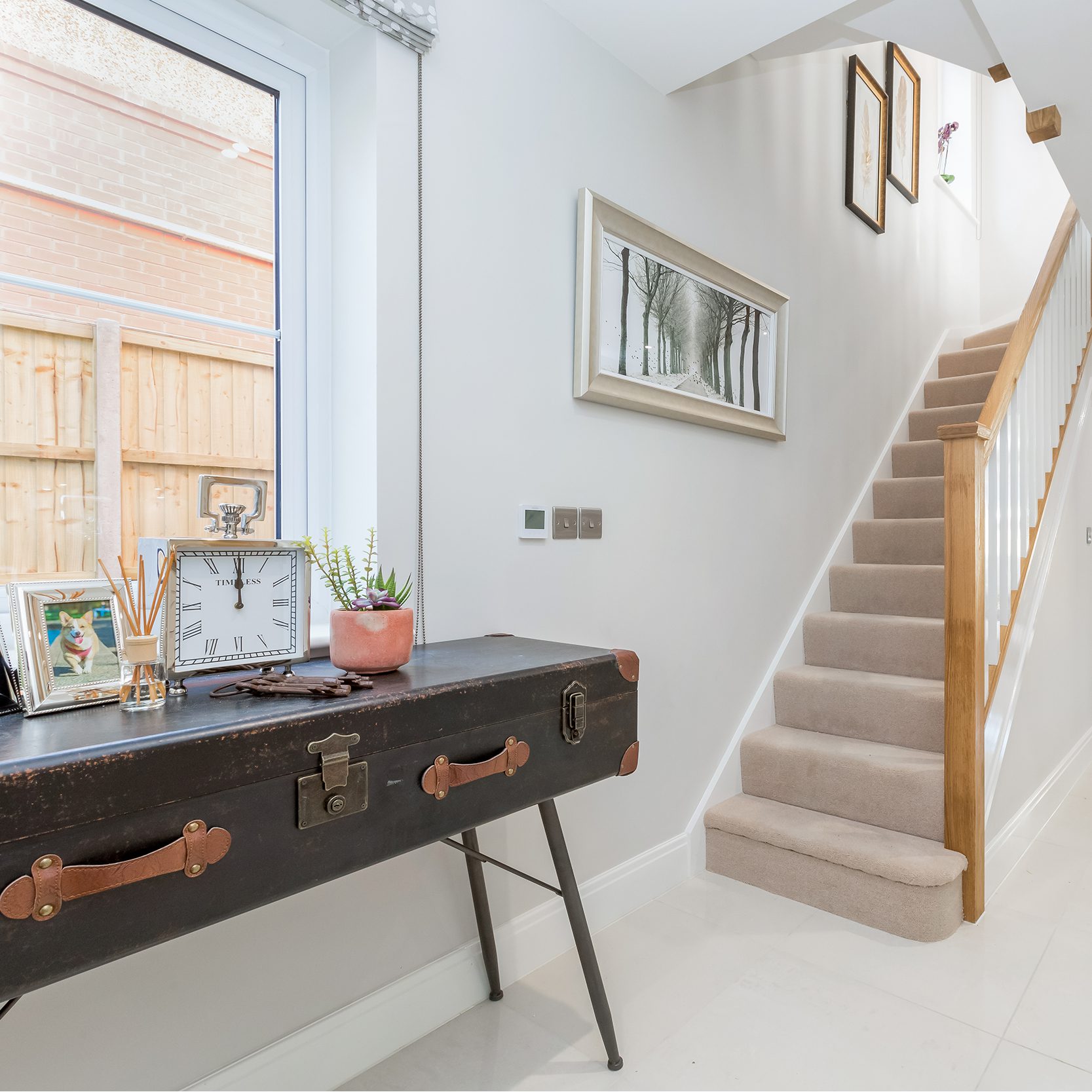 Spacious hallway with an console table made from an up cycled suitcase