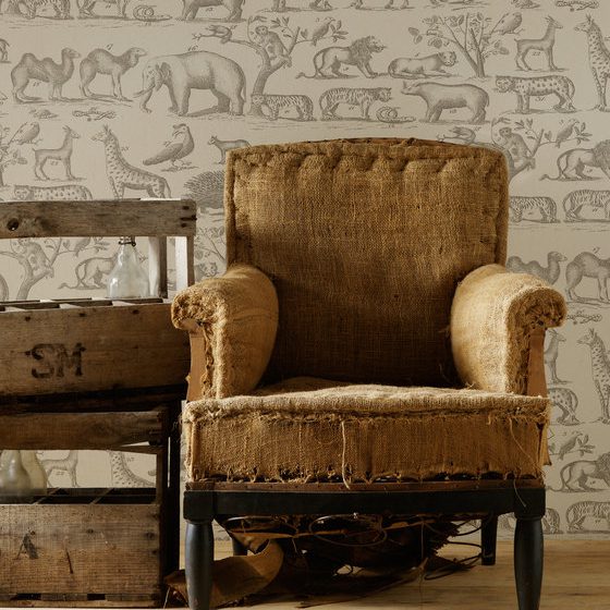 A hessian armchair in a room decorated with 100% paper, in the design of Noah's ark.
