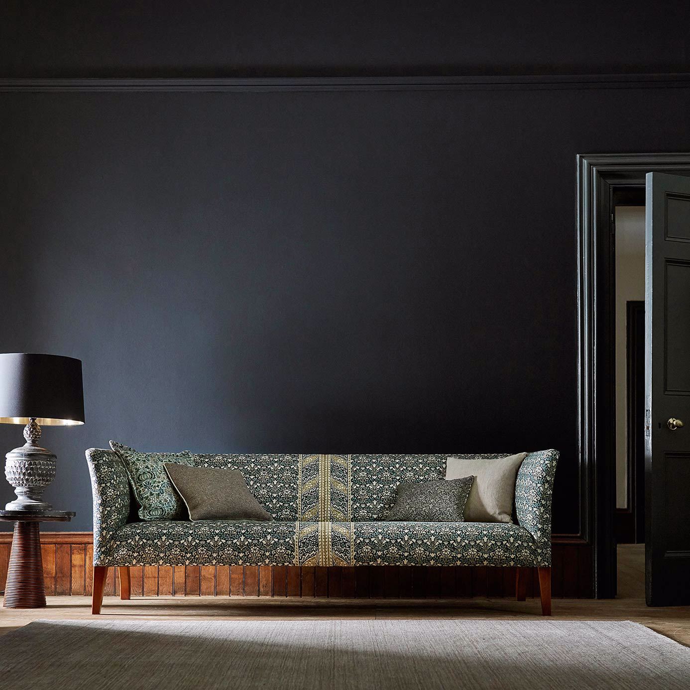 Elegant but traditional sofa in a room painted black