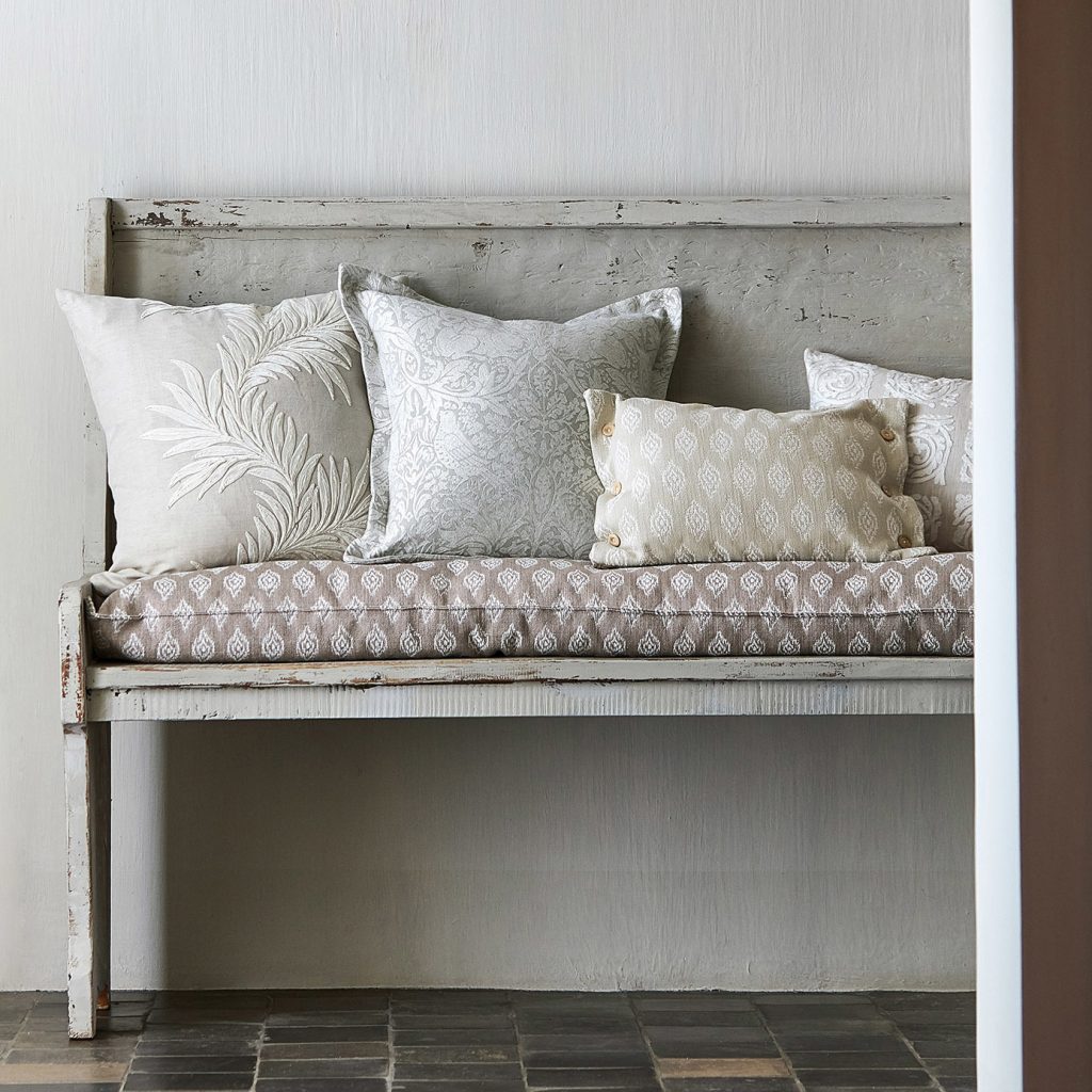 Grey painted bench with natural scatter cushions