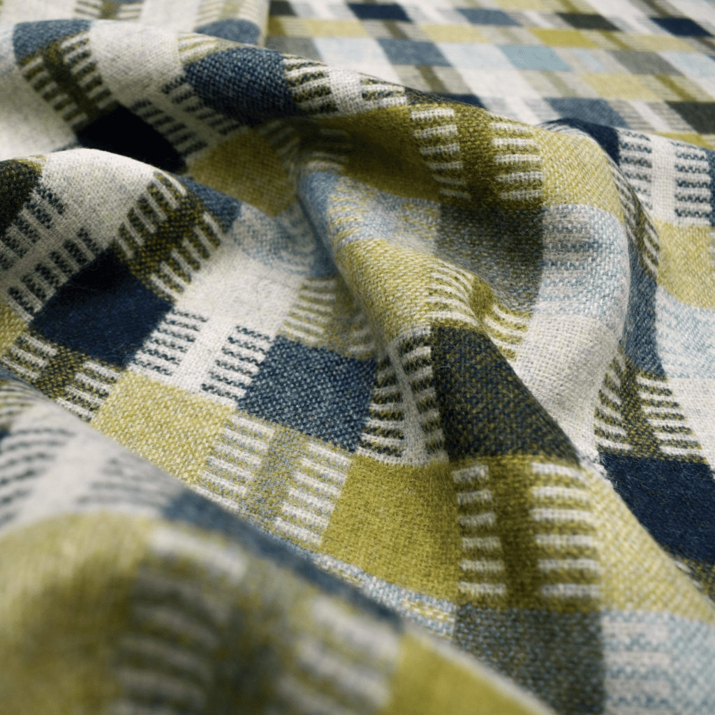 Pure wool furnishing fabric in neutral and green shades.