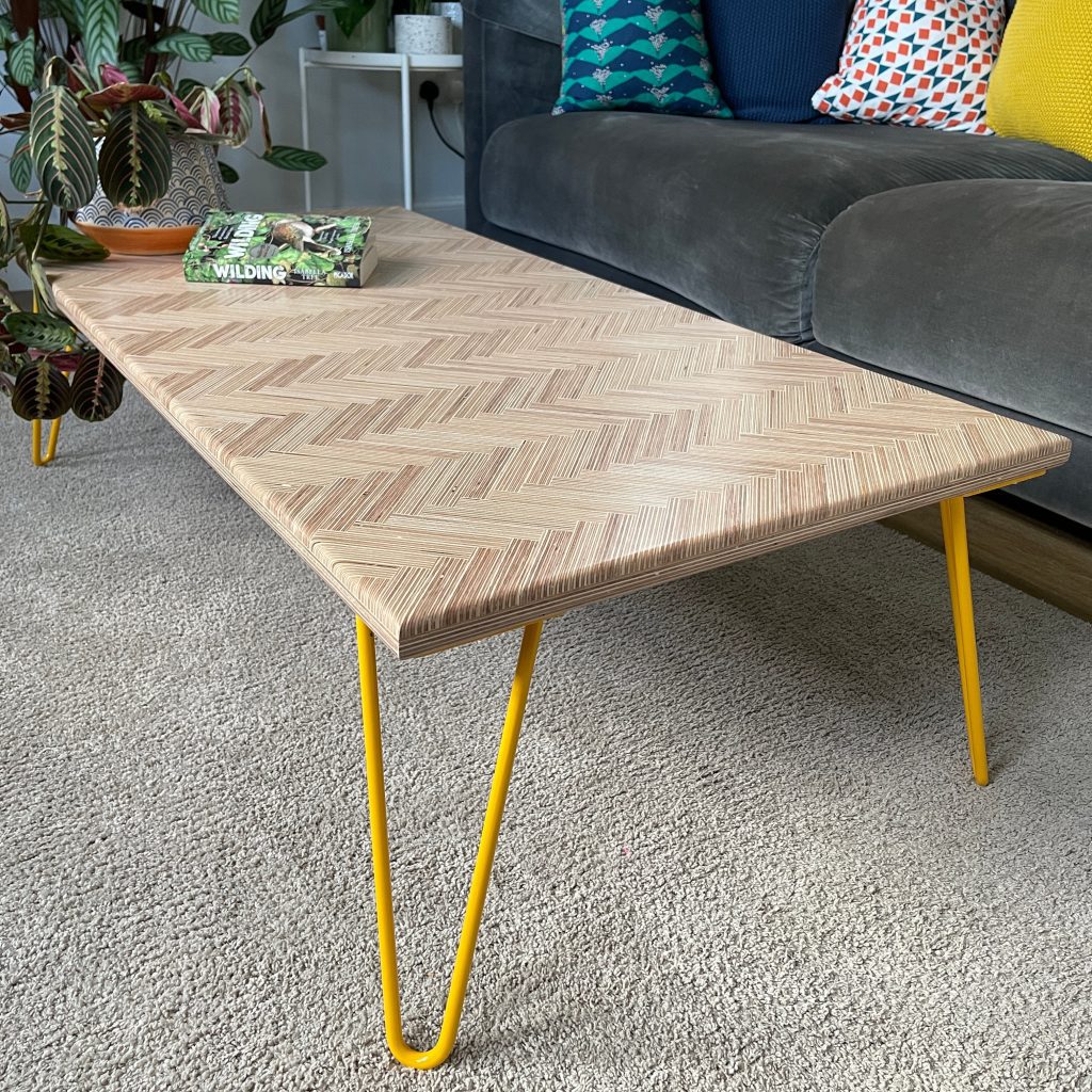 Modern coffee table made from plywood and yellow hairpin legs