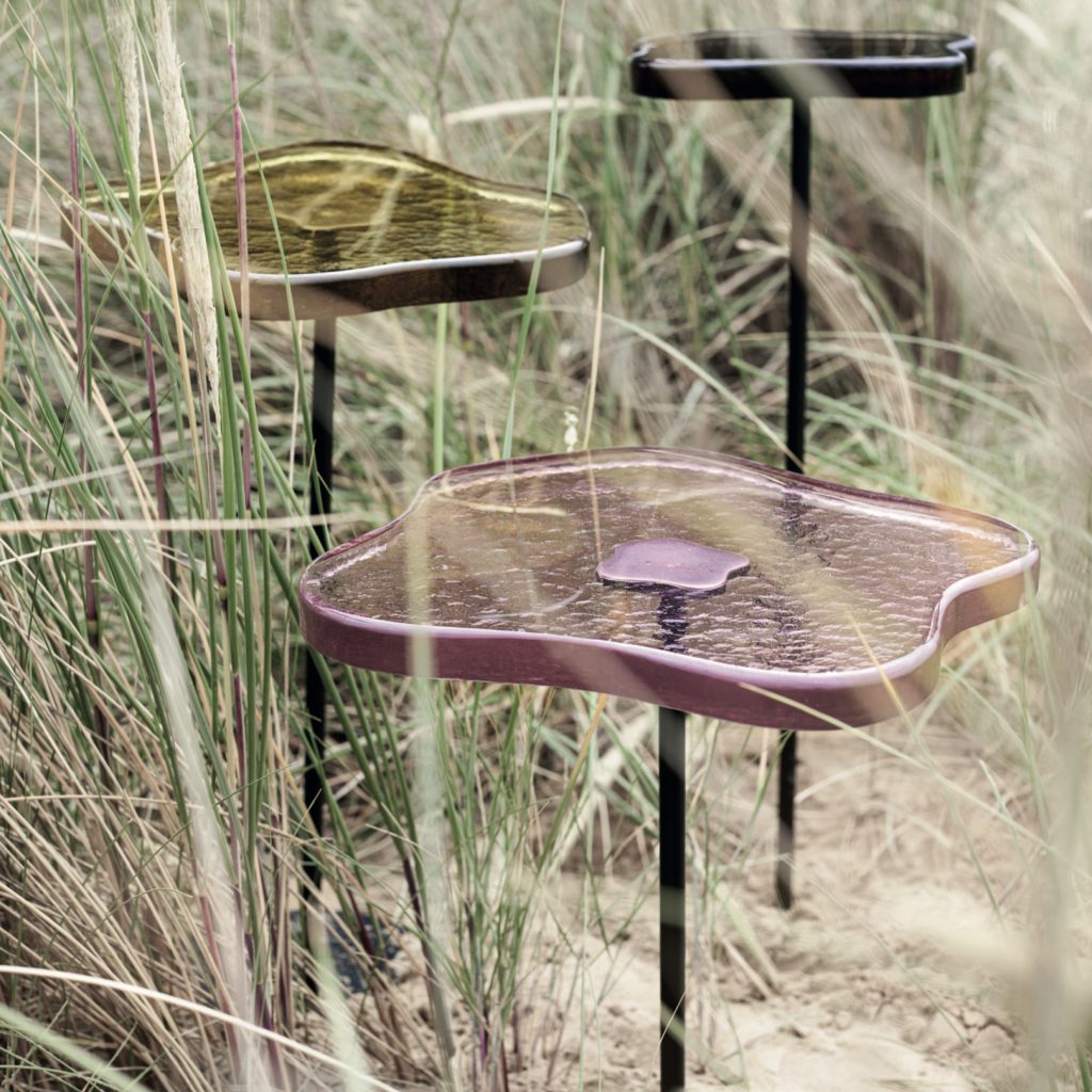 Bronze side tables with hand-cast
coloured glass tops