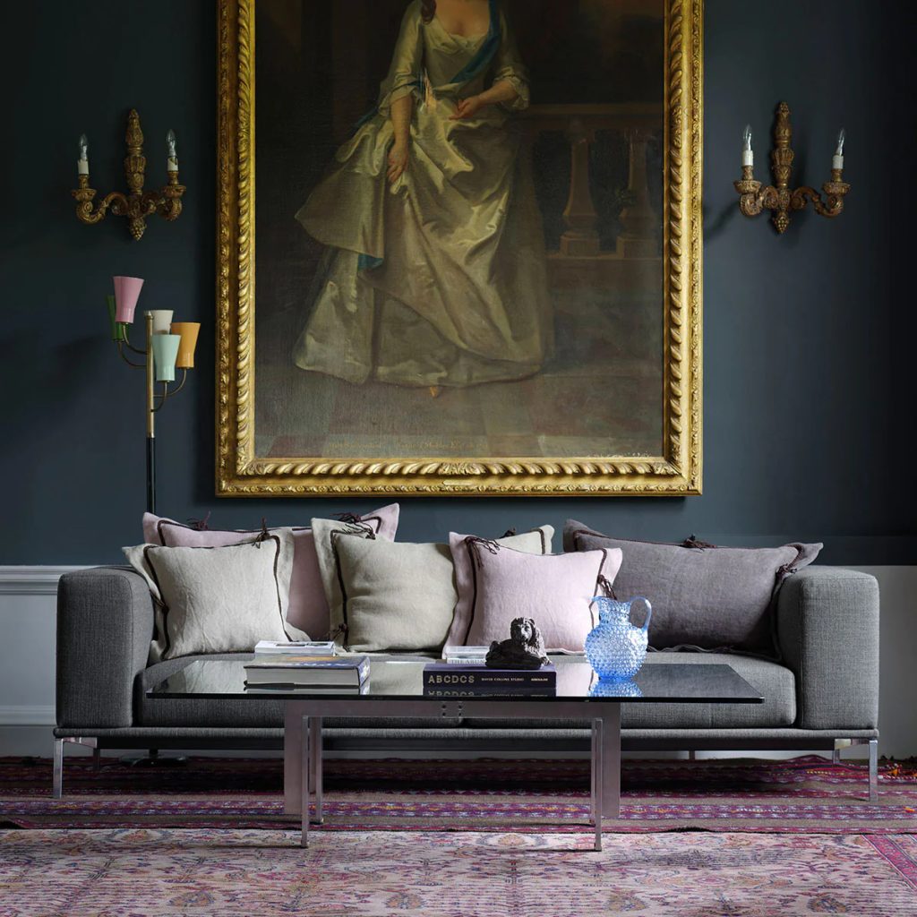 Elegant drawing room with a grey linen sofa and scatter cushions in dusky pink and natural linen
