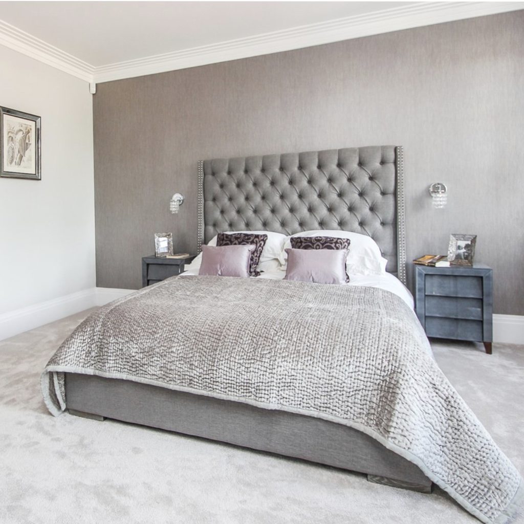 Grey bedroom with buttoned headboard and grey velvet bedspread