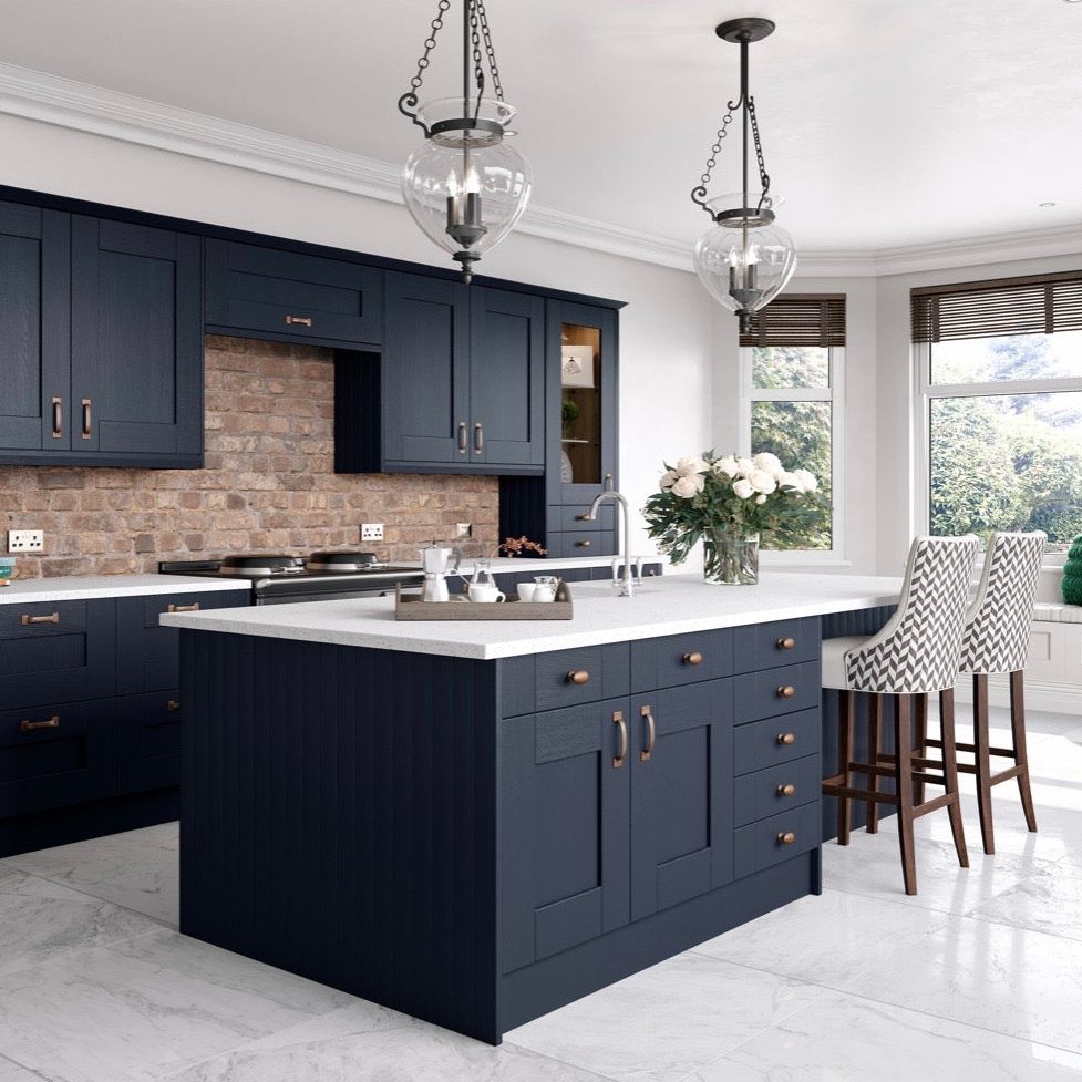 Indigo blue painted shaker kitchen with exposed brick wall