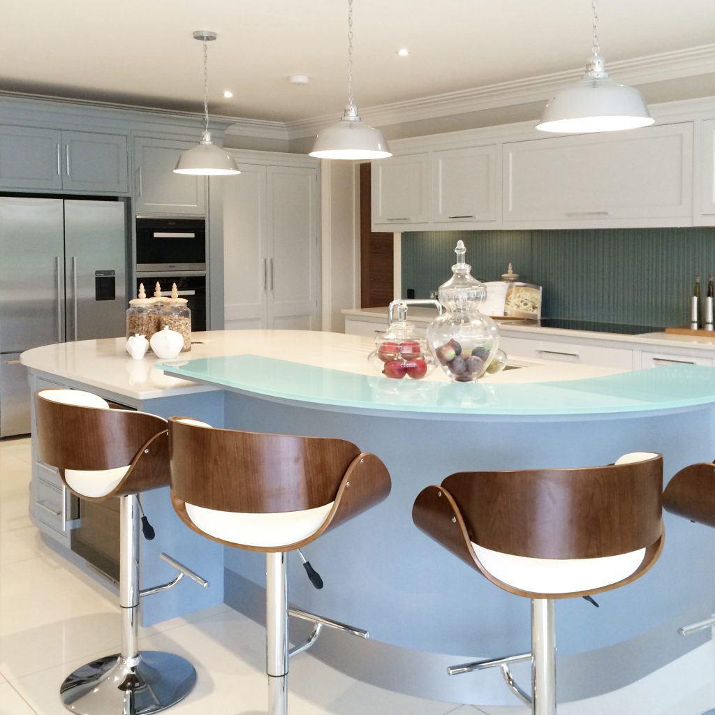 Pale blue shaker kitchen with walnut bar stools