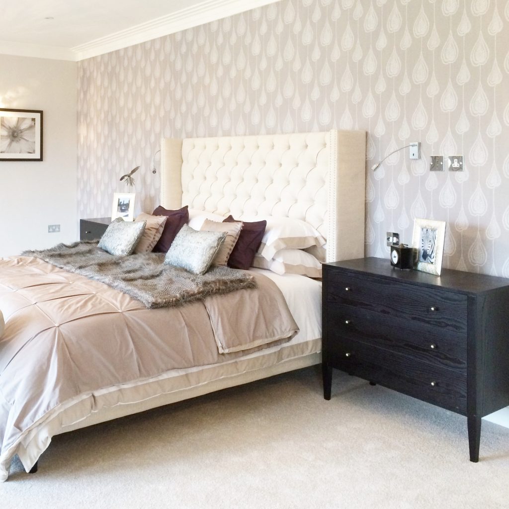 A master bedroom decorated in delicate neutral and dusky pink shades