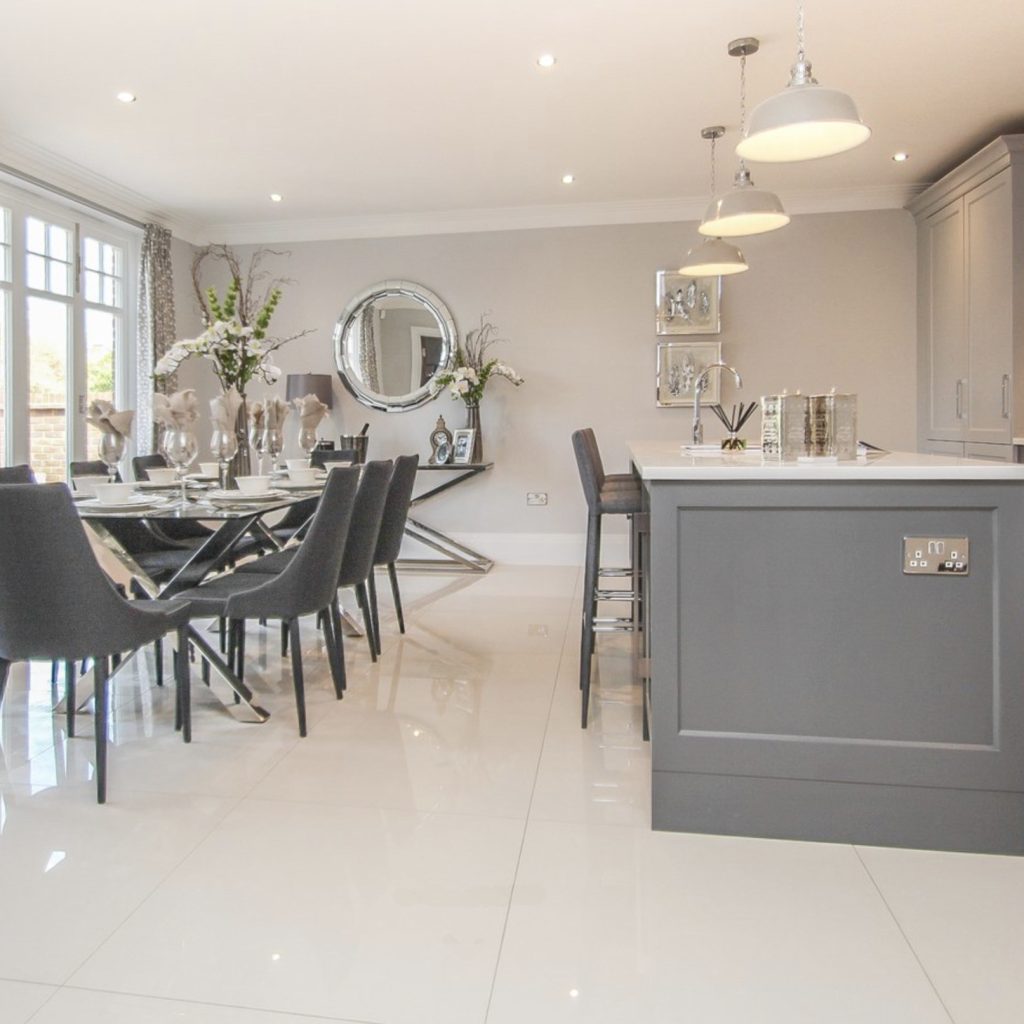 Grey shaker kitchen with glass dining table and grey chairs