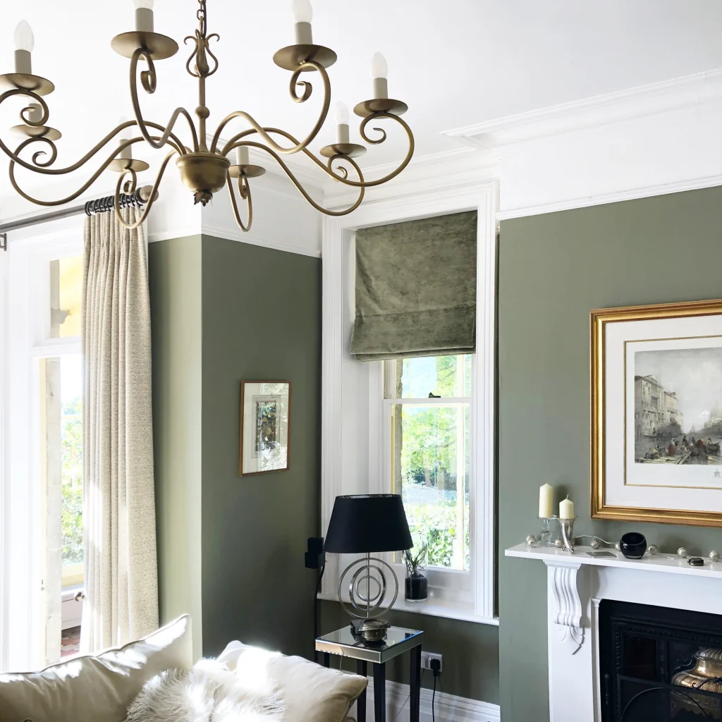 A classically styled drawing room decorated in olive green
