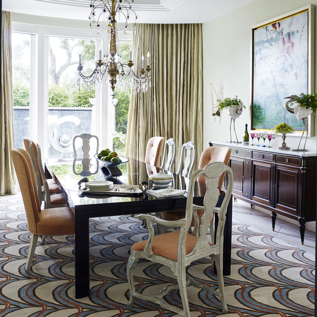 A traditional dining room with period sideboard and chairs but with an ultra modern table