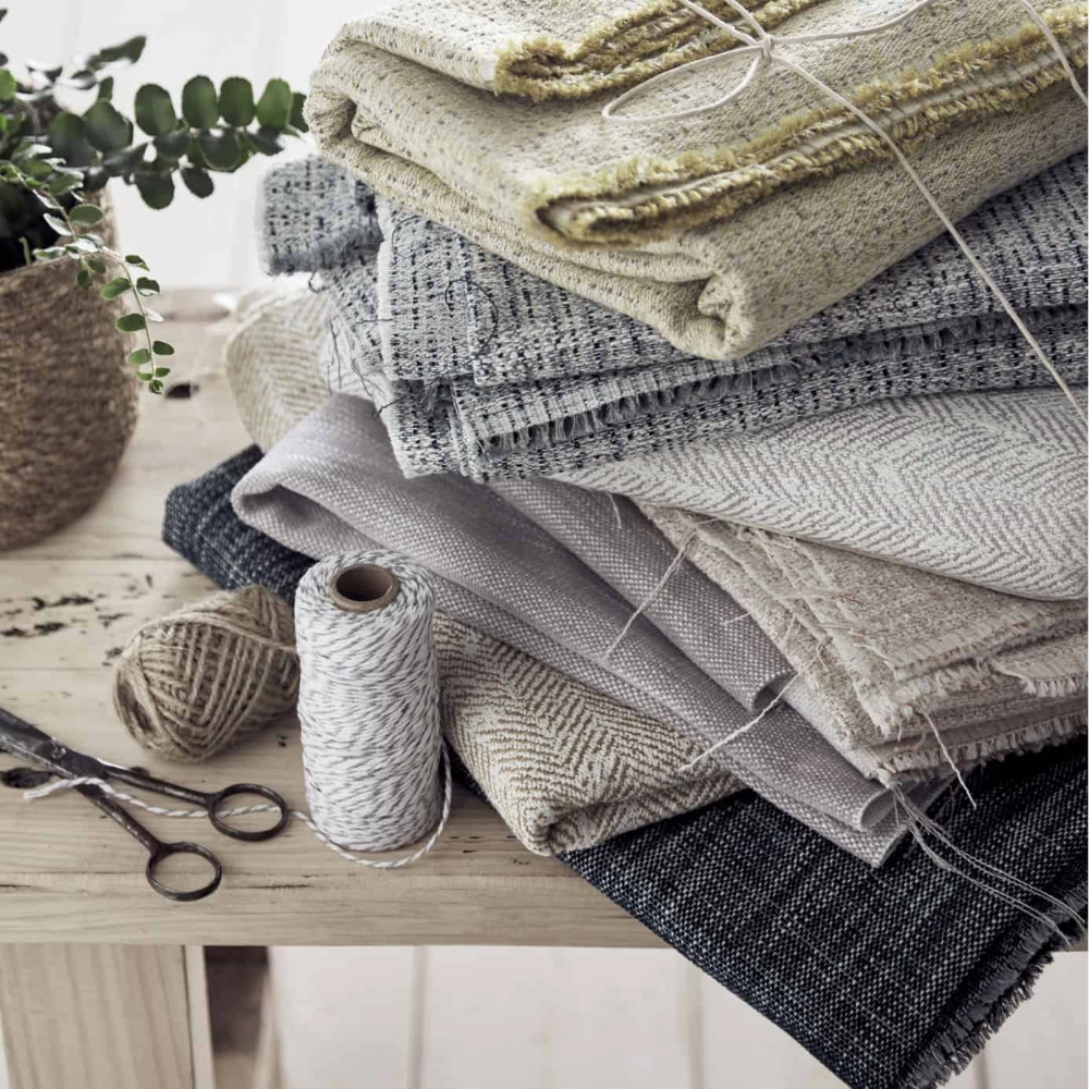 A stack of folded pieces of fabric on a wooden table