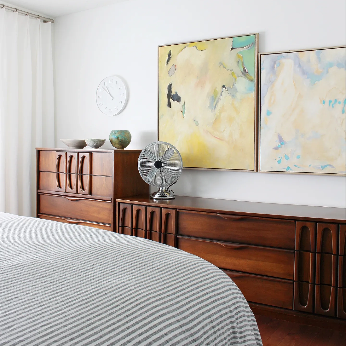 Mid century teak chests in a white bedroom