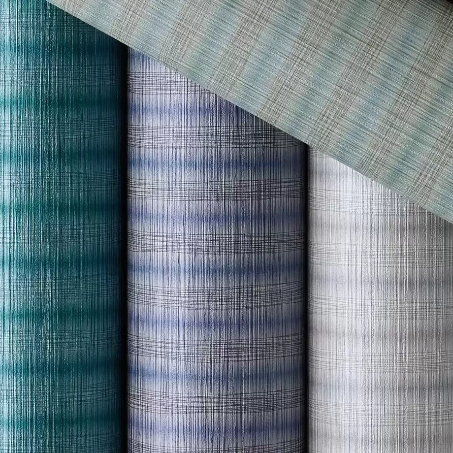 Rolls of vinyl wallcovering in shades of teal, duck egg green and a lilac-blue