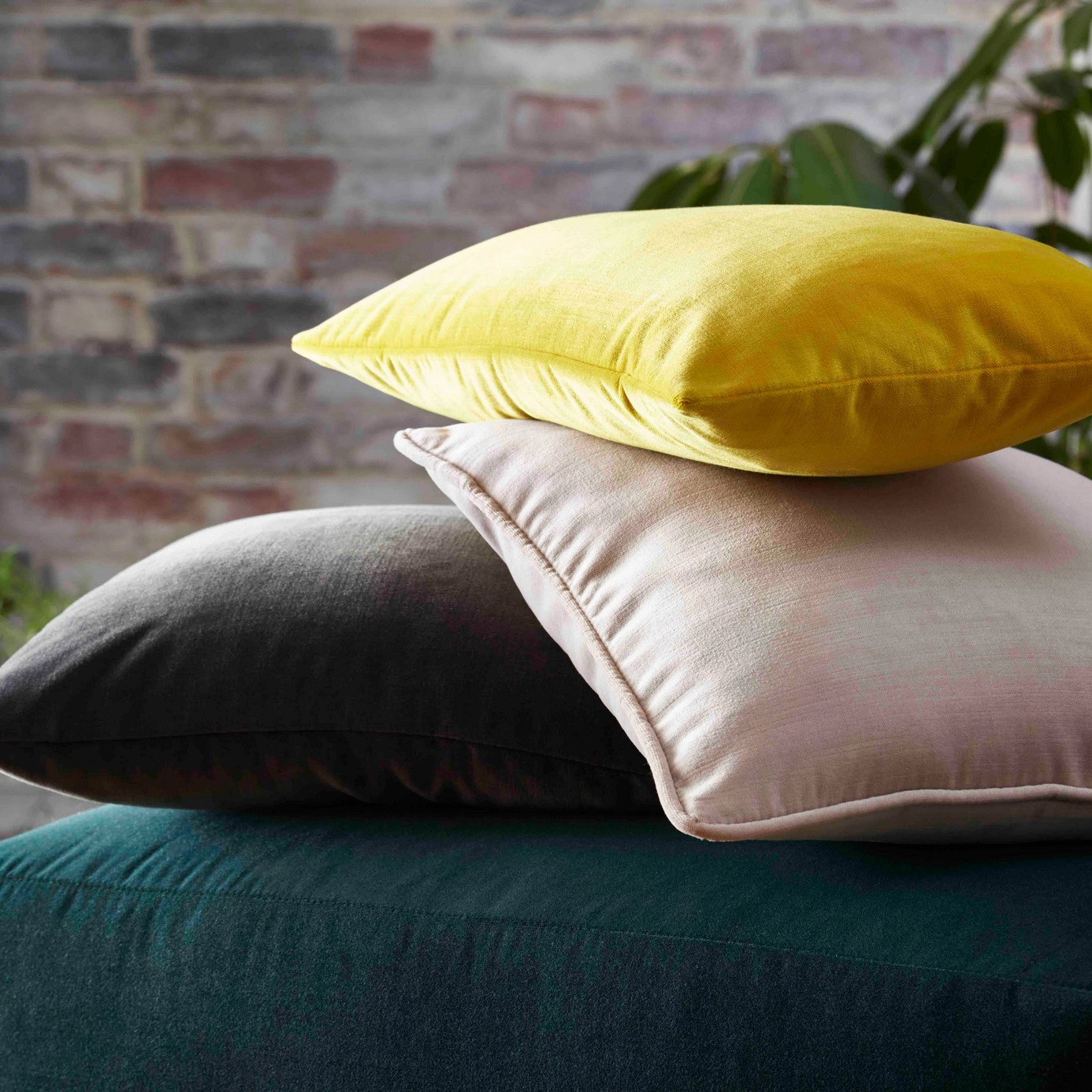 A stack of velvet cushions made from recycled polyester