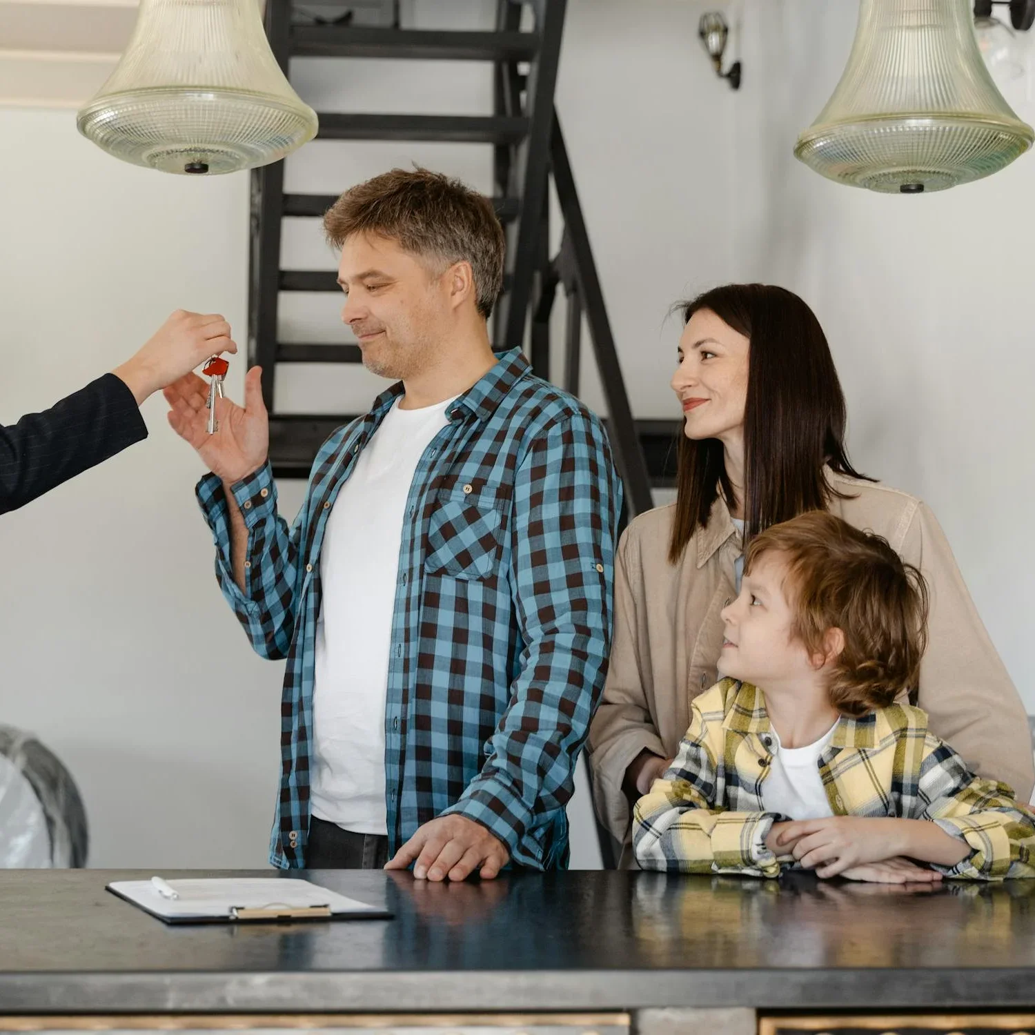 A family being handed the keys to their new home