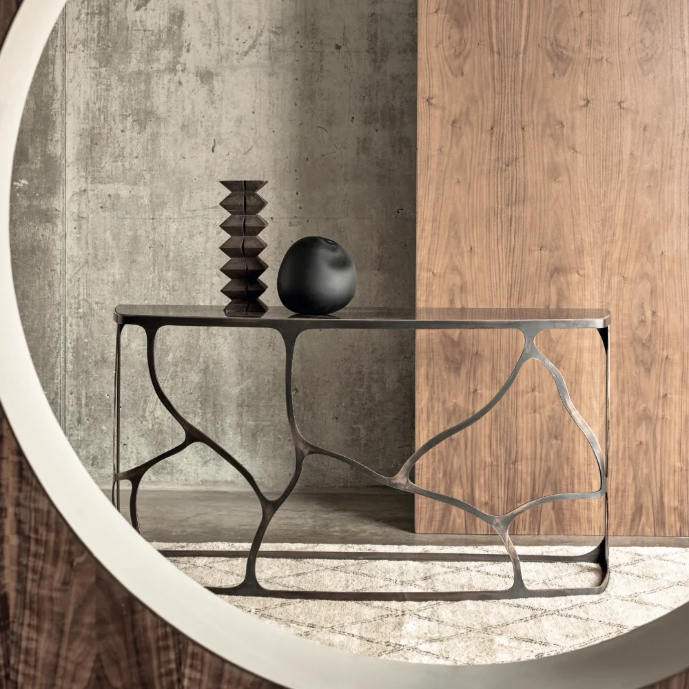 A contemporary style console table in metal and glass