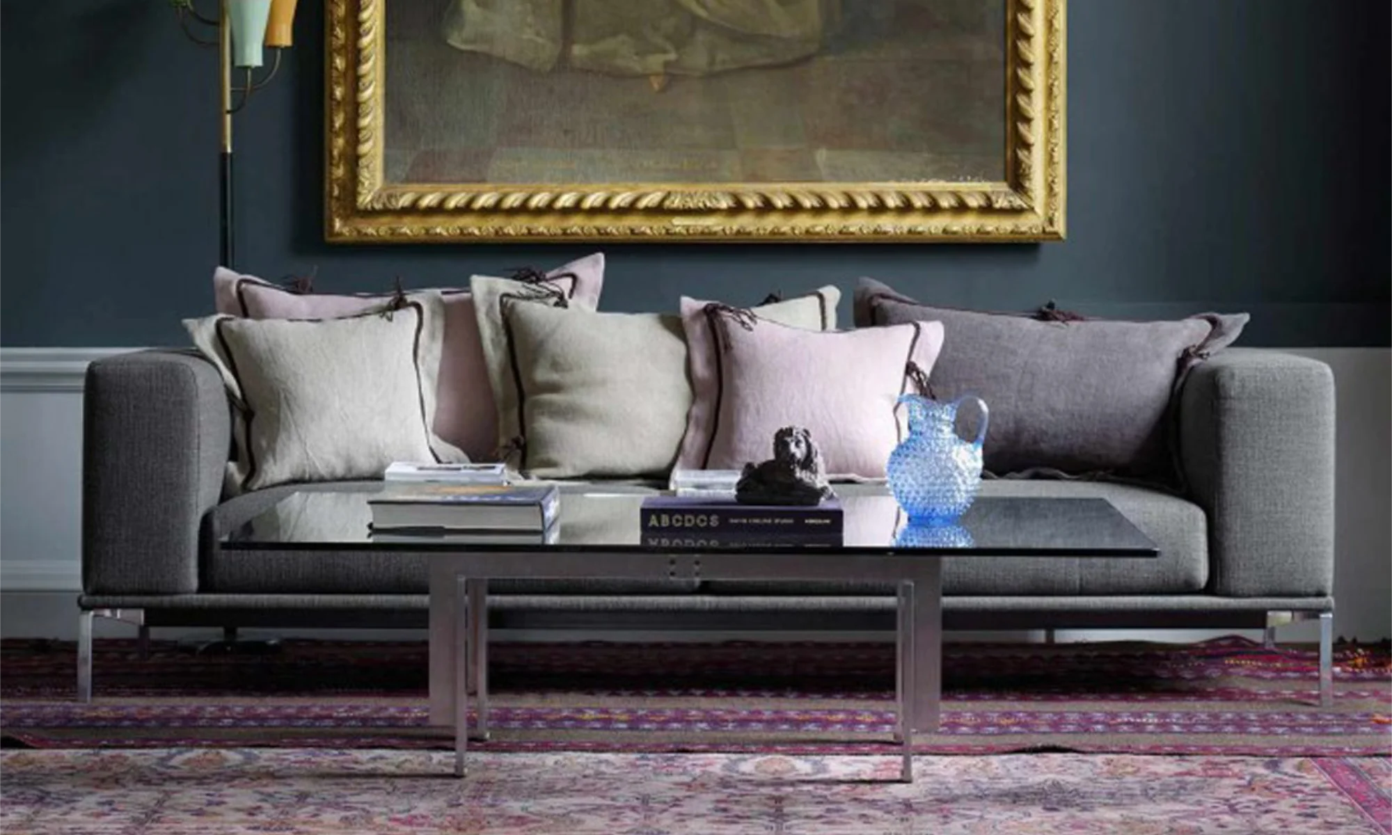 A modern grey sofa with a selection of pastel scatter cushions in linen