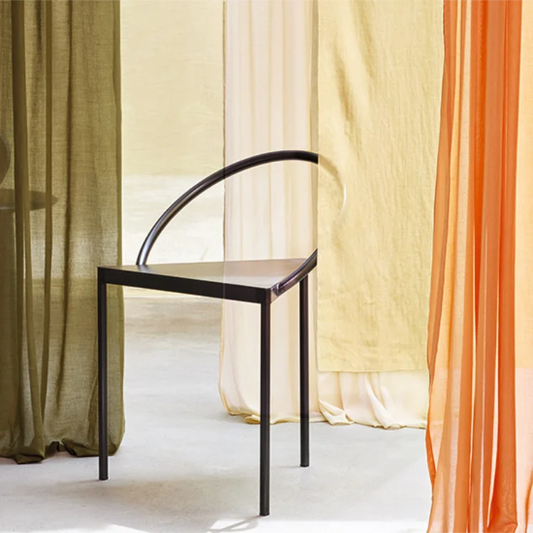 Panels of voile hanging behind a modern chair